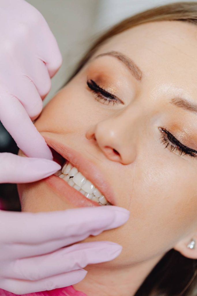 Dental professional examines patient's front teeth in close-up clinical view